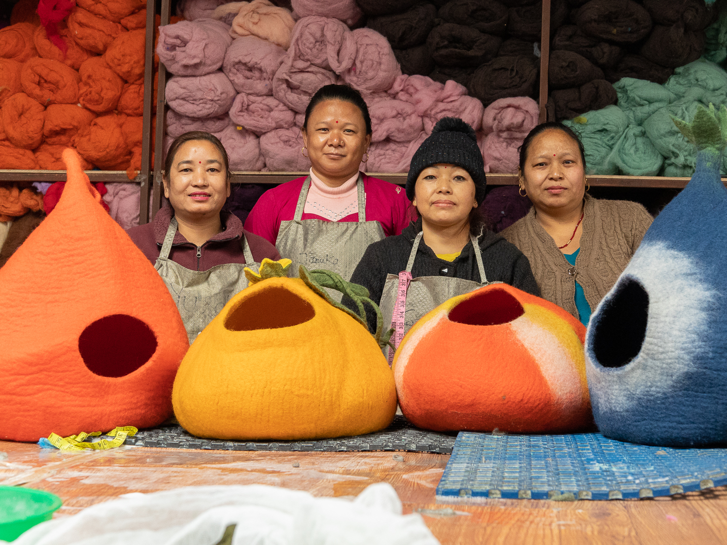 Women artisans handcrafting felt cat caves